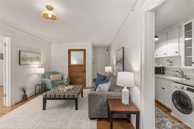 4725 15th Ave NE Unit 22, Seattle, WA 98105 - living room featuring washer / clothes dryer and light wood-style floors