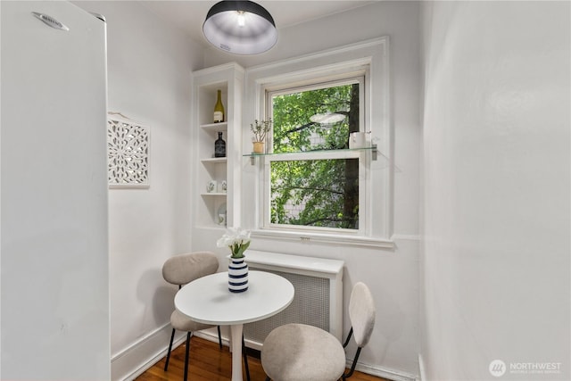 4725 15th Ave NE Unit 22, Seattle, WA 98105 - dining space featuring radiator heating unit and wood finished floors