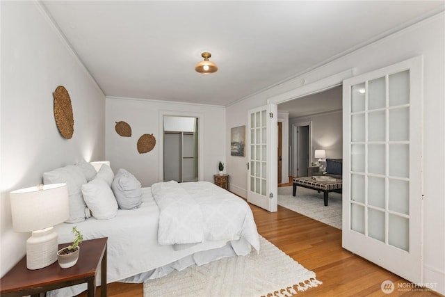 4725 15th Ave NE Unit 22, Seattle, WA 98105 - bedroom with french doors, wood finished floors, and a closet