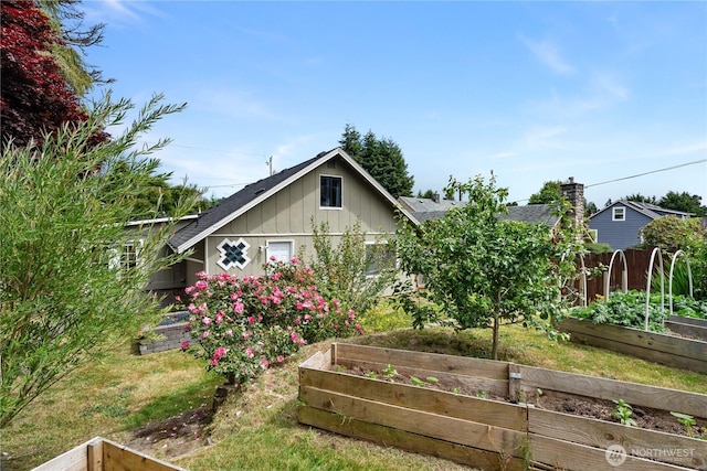 2717 Bench Dr, Aberdeen, WA 98520 - view of front of property with a vegetable garden, board and batten siding, roof with shingles, and a chimney