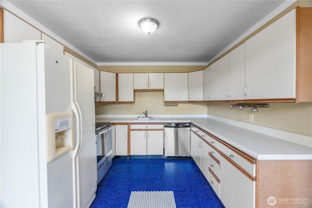 2717 Bench Dr, Aberdeen, WA 98520 - kitchen featuring appliances with stainless steel finishes, light countertops, and white cabinets