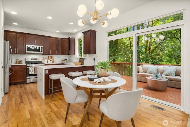 16760 128th Pl NE, Woodinville, WA 98072 - kitchen featuring appliances with stainless steel finishes, dark brown cabinetry, light countertops, recessed lighting, and light wood-style flooring