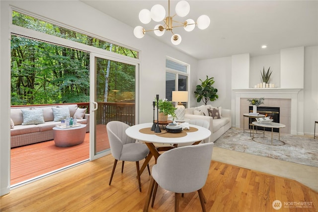 16760 128th Pl NE, Woodinville, WA 98072 - dining room with a tile fireplace, light wood-style floors, a chandelier, and recessed lighting