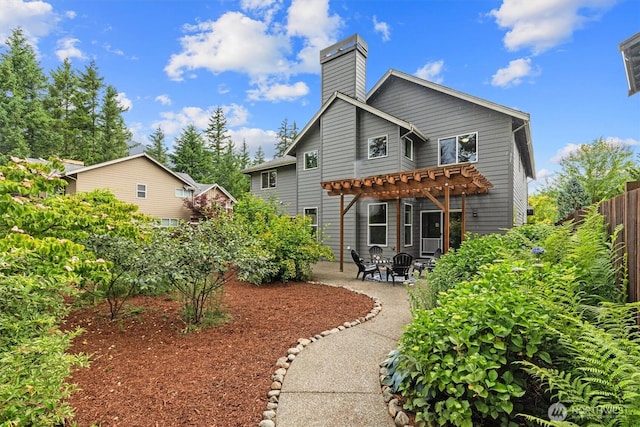 1635 Tannerwood Way SE, North Bend, WA 98045 - back of property featuring a pergola, a patio, and a chimney