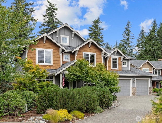 1635 Tannerwood Way SE, North Bend, WA 98045 - craftsman house with board and batten siding, roof with shingles, driveway, and stone siding