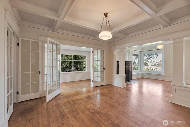 715 W Howe St, Seattle, WA 98119 - unfurnished living room featuring french doors, ornate columns, coffered ceiling, hardwood / wood-style floors, and beamed ceiling