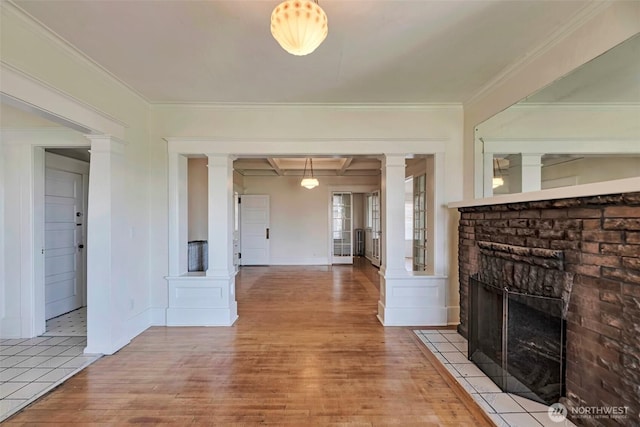 715 W Howe St, Seattle, WA 98119 - unfurnished living room featuring decorative columns, hardwood / wood-style floors, a fireplace, and ornamental molding