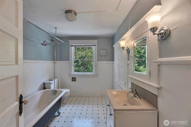 715 W Howe St, Seattle, WA 98119 - bathroom featuring a tub, vanity, tile patterned floors, wainscoting, and a shower