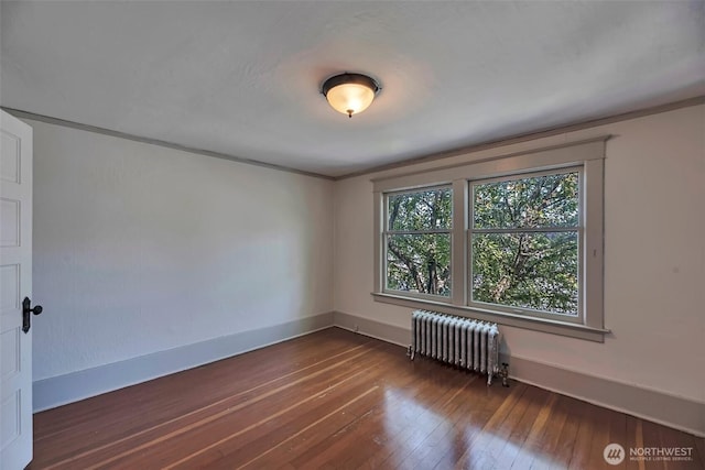 715 W Howe St, Seattle, WA 98119 - spare room featuring radiator, hardwood / wood-style floors, and crown molding