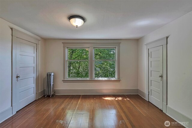 715 W Howe St, Seattle, WA 98119 - spare room featuring radiator heating unit and wood-type flooring