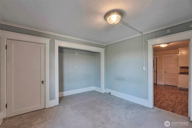 715 W Howe St, Seattle, WA 98119 - unfurnished bedroom featuring crown molding, carpet flooring, and a closet