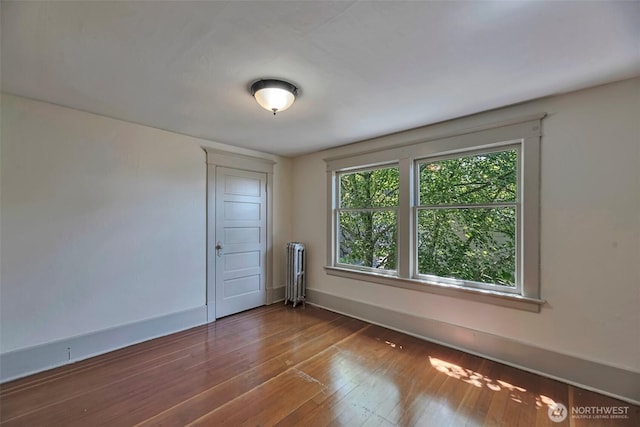 715 W Howe St, Seattle, WA 98119 - spare room with radiator heating unit and hardwood / wood-style floors