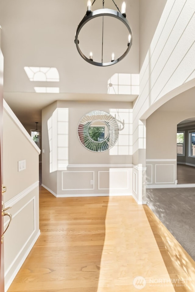 456 Sorensen St, Buckley, WA 98321 - entrance foyer with a chandelier, a decorative wall, arched walkways, wood finished floors, and a towering ceiling