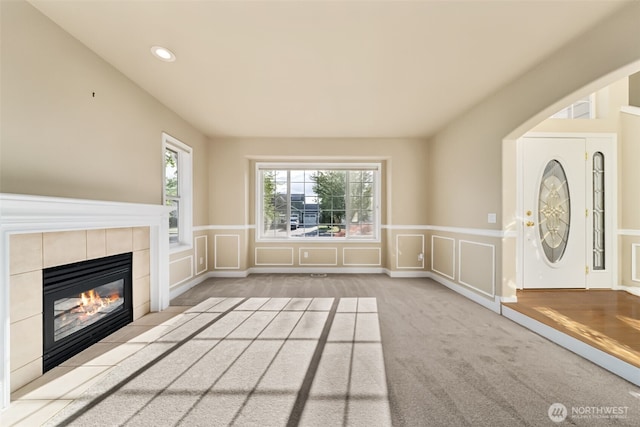 456 Sorensen St, Buckley, WA 98321 - unfurnished living room with wainscoting, a decorative wall, a tile fireplace, recessed lighting, and carpet flooring