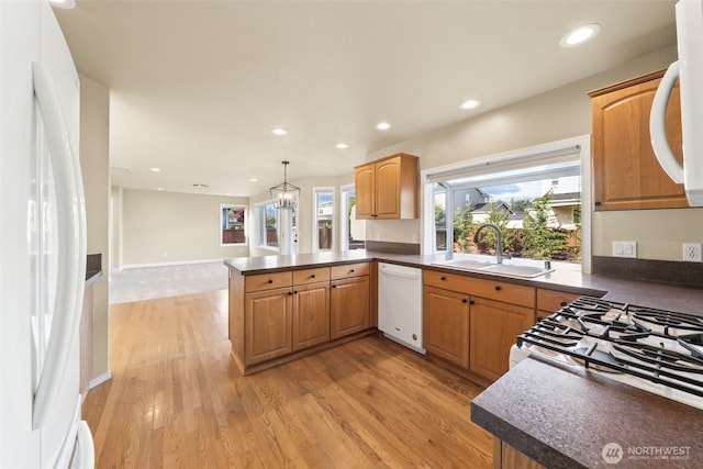 456 Sorensen St, Buckley, WA 98321 - kitchen with white appliances, a peninsula, dark countertops, light wood-type flooring, and recessed lighting
