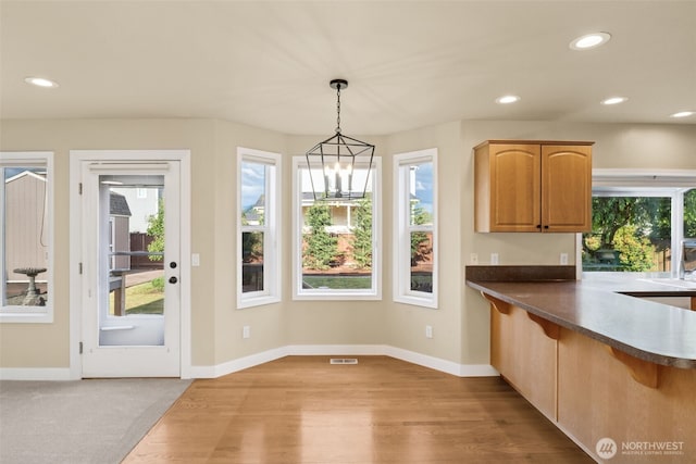 456 Sorensen St, Buckley, WA 98321 - kitchen featuring light wood finished floors, a breakfast bar area, recessed lighting, decorative light fixtures, and dark countertops