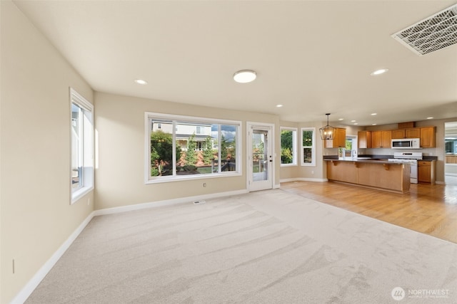456 Sorensen St, Buckley, WA 98321 - unfurnished living room featuring light colored carpet and recessed lighting
