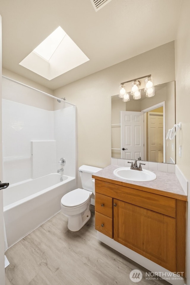 456 Sorensen St, Buckley, WA 98321 - bathroom with a skylight, wood finished floors, vanity, and shower / bathtub combination