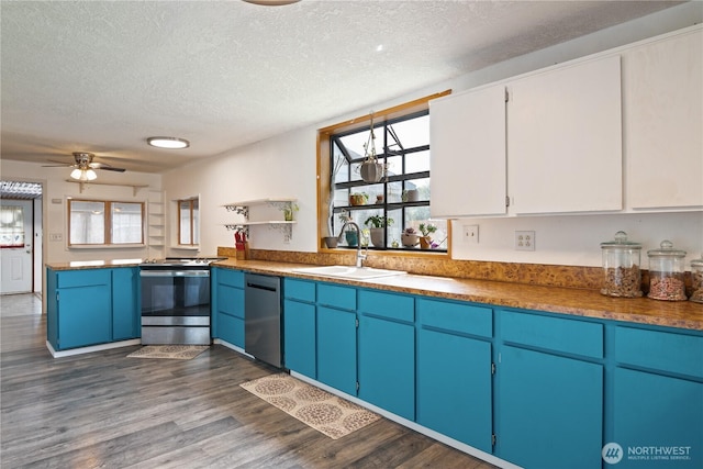 618 Main St, Vader, WA 98593 - kitchen featuring appliances with stainless steel finishes, a textured ceiling, open shelves, plenty of natural light, and dark wood-style flooring