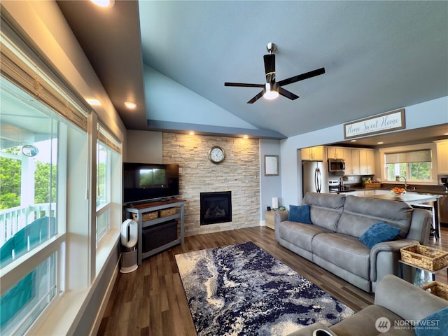 1155 Greenview Ave SW, Ocean Shores, WA 98569 - living room featuring vaulted ceiling, a fireplace, ceiling fan, and dark wood-style floors