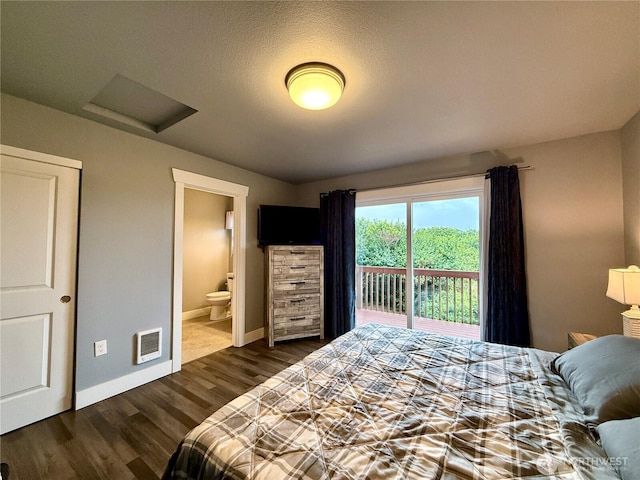 1155 Greenview Ave SW, Ocean Shores, WA 98569 - bedroom featuring access to outside, attic access, dark wood finished floors, connected bathroom, and heating unit