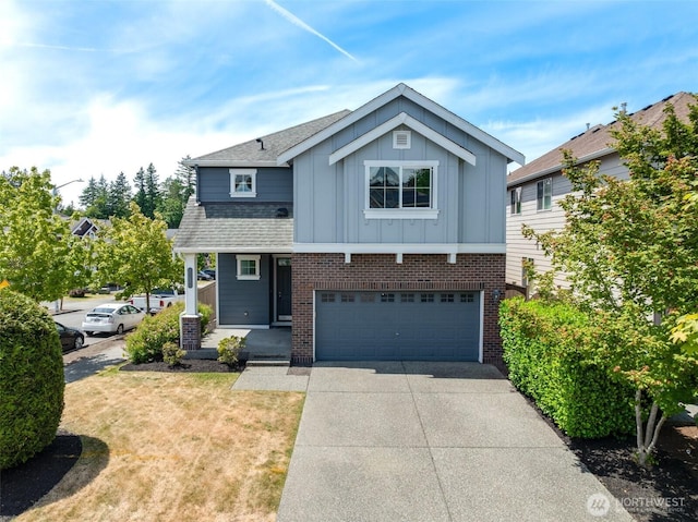 1130 77th Dr SE, Lake Stevens, WA 98258 - view of front facade with board and batten siding, concrete driveway, a garage, and brick siding