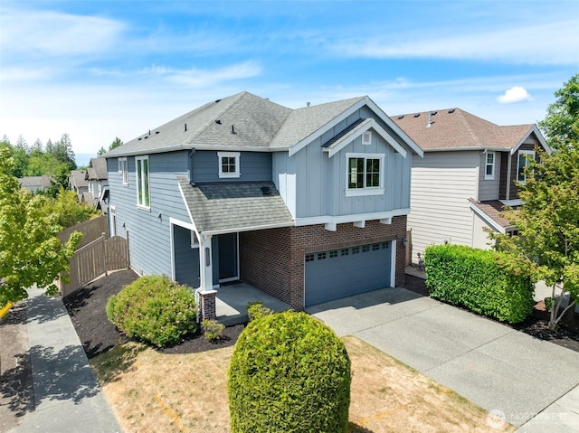 1130 77th Dr SE, Lake Stevens, WA 98258 - traditional-style house featuring board and batten siding, brick siding, an attached garage, driveway, and roof with shingles