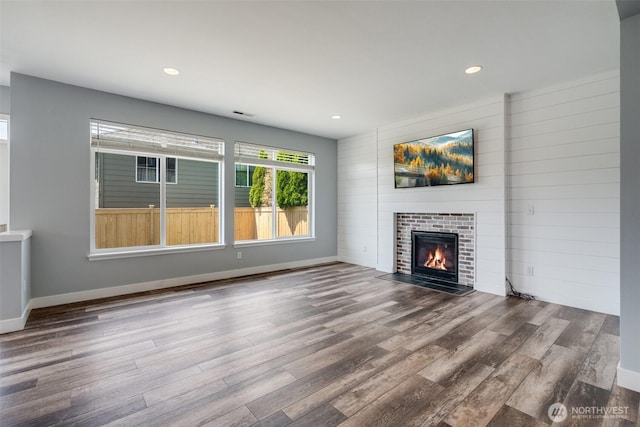 1130 77th Dr SE, Lake Stevens, WA 98258 - unfurnished living room with wood finished floors, a tile fireplace, and recessed lighting