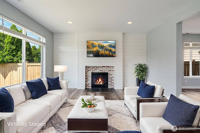 1130 77th Dr SE, Lake Stevens, WA 98258 - living room featuring wood finished floors, healthy amount of natural light, a fireplace with flush hearth, recessed lighting, and wood walls