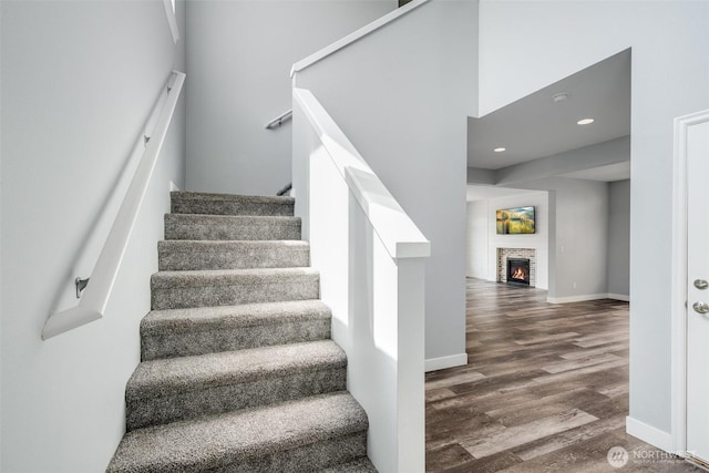 1130 77th Dr SE, Lake Stevens, WA 98258 - stairs with wood finished floors, a glass covered fireplace, and recessed lighting