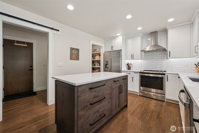 6518 73rd Ave E, Olympia, WA 98516 - kitchen with appliances with stainless steel finishes, wall chimney exhaust hood, white cabinets, light countertops, and recessed lighting