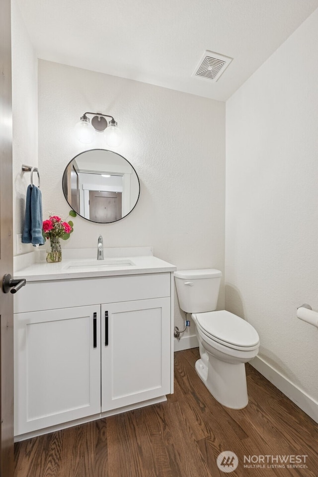 6518 73rd Ave E, Olympia, WA 98516 - half bathroom featuring vanity and wood finished floors