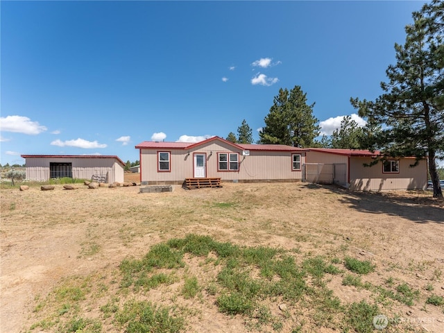 115 Hummingbird Rd, East Wenatchee, WA 98802 - back of property with entry steps and an outdoor structure