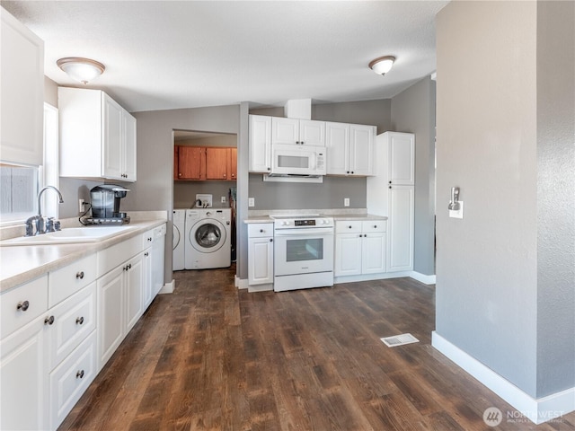 115 Hummingbird Rd, East Wenatchee, WA 98802 - kitchen featuring white appliances, separate washer and dryer, dark wood finished floors, light countertops, and white cabinetry