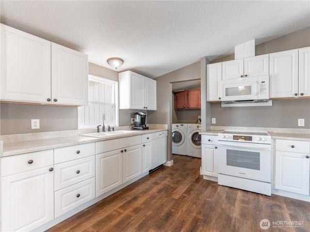 115 Hummingbird Rd, East Wenatchee, WA 98802 - kitchen with washing machine and clothes dryer, white appliances, lofted ceiling, white cabinets, and light countertops