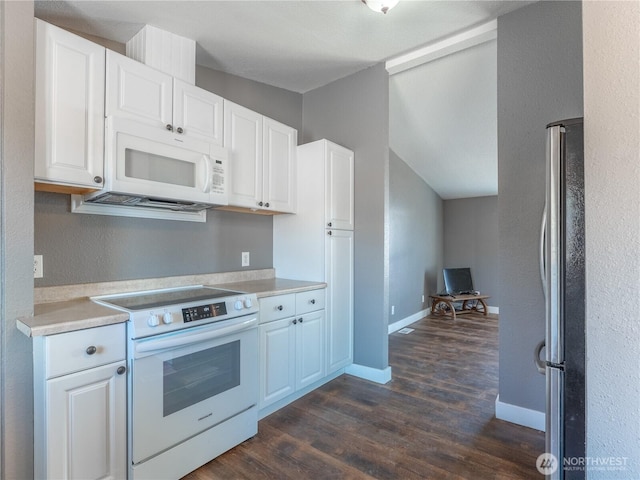 115 Hummingbird Rd, East Wenatchee, WA 98802 - kitchen with white appliances, dark wood-style floors, lofted ceiling, white cabinetry, and light countertops