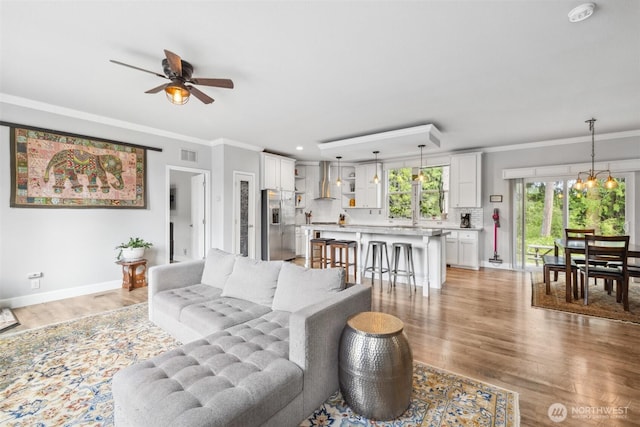 1966 Hooker Rd, Sequim, WA 98382 - living room featuring light wood-type flooring, ornamental molding, and ceiling fan