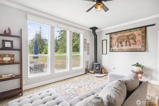 1966 Hooker Rd, Sequim, WA 98382 - living room with a wood stove, ceiling fan, and crown molding