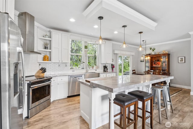 1966 Hooker Rd, Sequim, WA 98382 - kitchen featuring stainless steel appliances, crown molding, open shelves, tasteful backsplash, and a center island