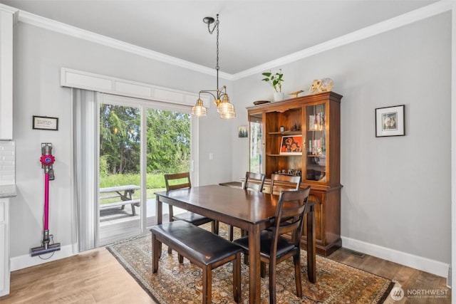 1966 Hooker Rd, Sequim, WA 98382 - dining space featuring ornamental molding, light wood-type flooring, and a chandelier