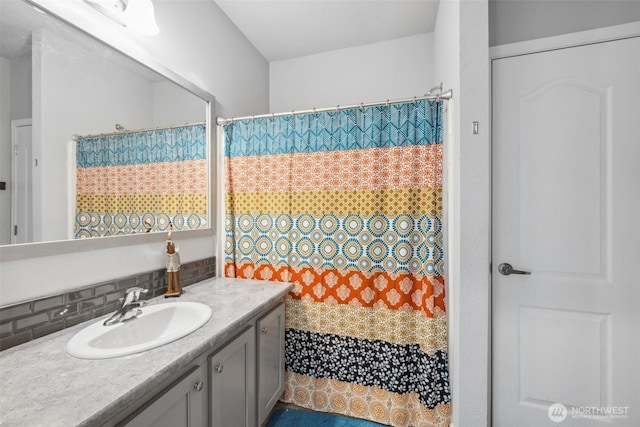 1966 Hooker Rd, Sequim, WA 98382 - full bathroom with vanity, decorative backsplash, and a shower with shower curtain