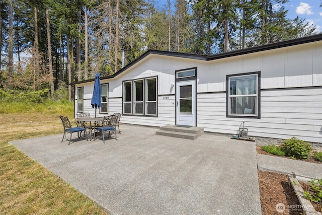 1966 Hooker Rd, Sequim, WA 98382 - rear view of property with a patio and board and batten siding