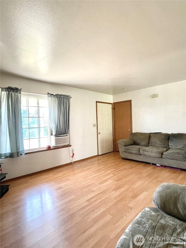 59G Copple Rd, Omak, WA 98841 - living area with light wood-style floors, a textured ceiling, and cooling unit