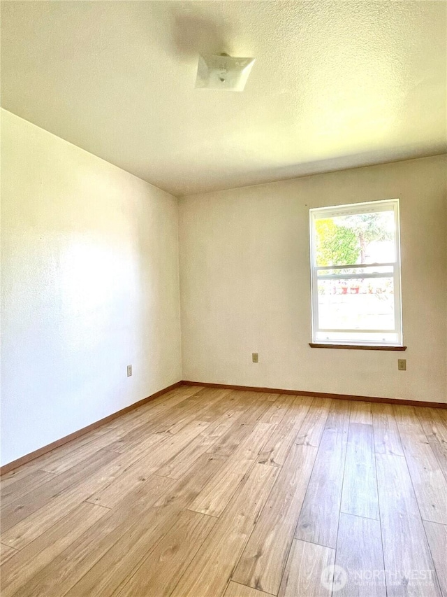 59G Copple Rd, Omak, WA 98841 - empty room featuring light wood-type flooring and a textured ceiling