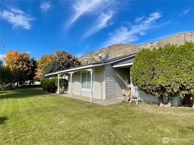 59G Copple Rd, Omak, WA 98841 - rear view of house featuring a lawn, a mountain view, and a patio area