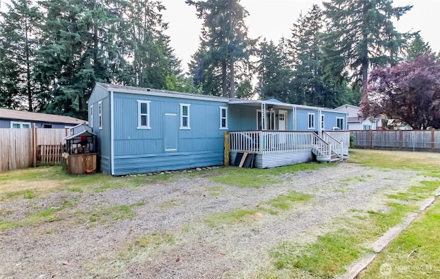 19820 63rd Avenue Ct E, Spanaway, WA 98387 - rear view of house featuring view of wooded area and a deck