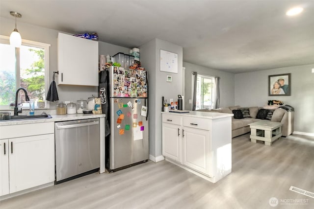 19820 63rd Avenue Ct E, Spanaway, WA 98387 - kitchen with appliances with stainless steel finishes, open floor plan, light wood-type flooring, and light countertops