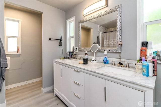 19820 63rd Avenue Ct E, Spanaway, WA 98387 - bathroom featuring double vanity and wood finished floors