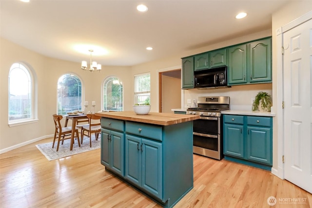 3112 87th Avenue Ct E, Edgewood, WA 98371 - kitchen with range with two ovens, black microwave, butcher block counters, a center island, and light wood-type flooring