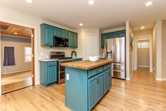 3112 87th Avenue Ct E, Edgewood, WA 98371 - kitchen featuring appliances with stainless steel finishes, wooden counters, a kitchen island, light wood-style floors, and recessed lighting